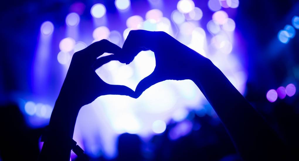 Hands make heart shape at nightclub