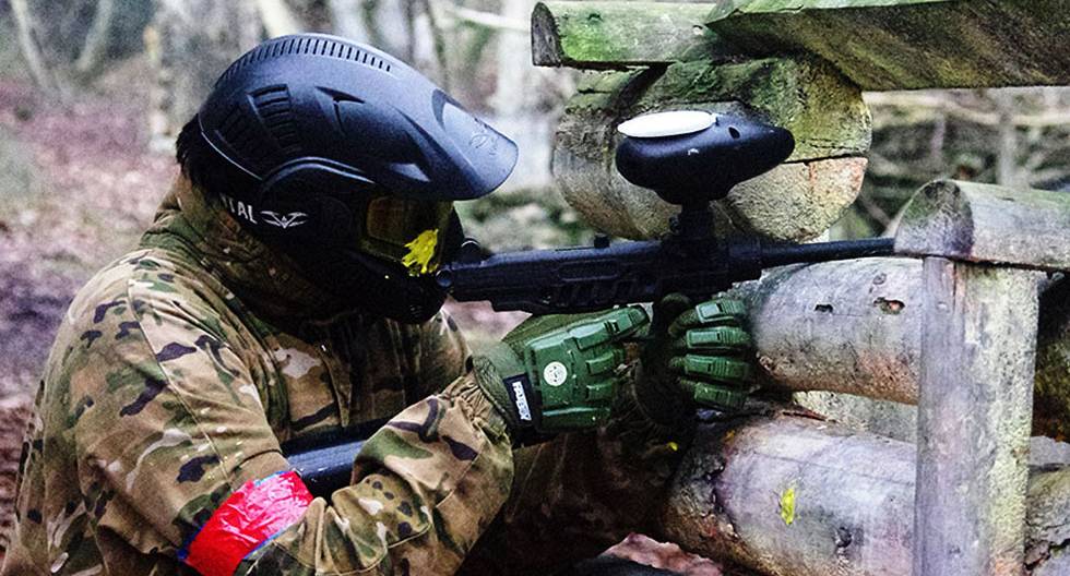 Paintball player taking cover 