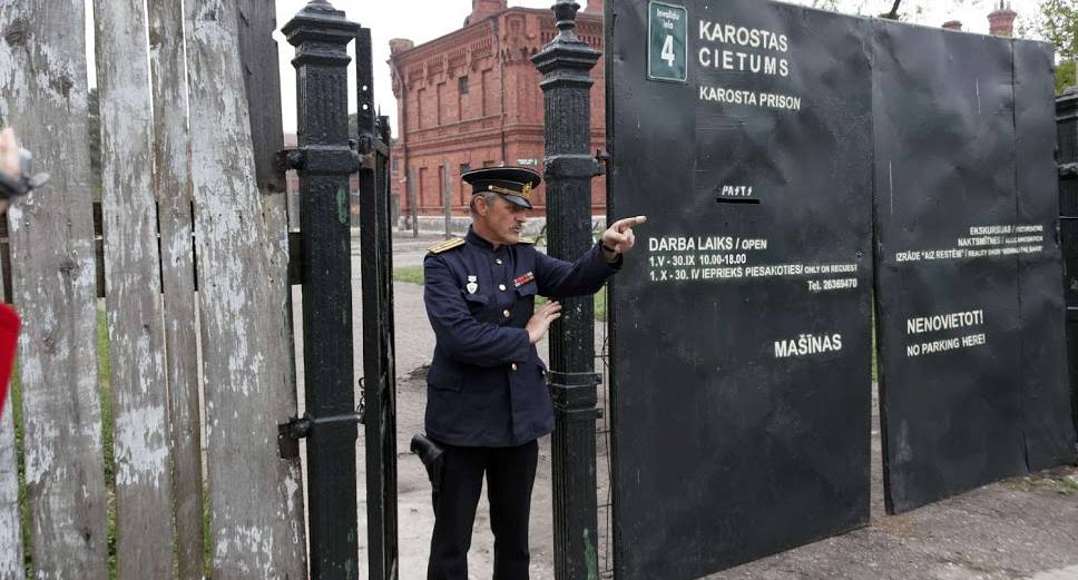 Officer welcomes groups to the Military Prison experience in Riga